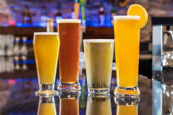 four drinks of different sizes and colors