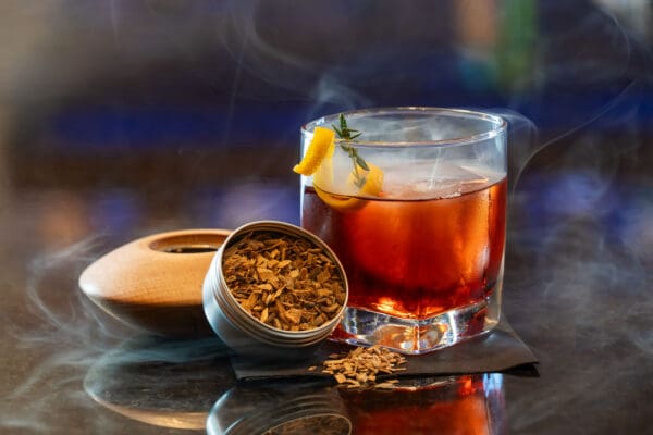 glass of red tea with an ice cube in it