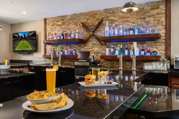 counter at the 5x5 cafe with soup and a drink, and burger, and fries behind
